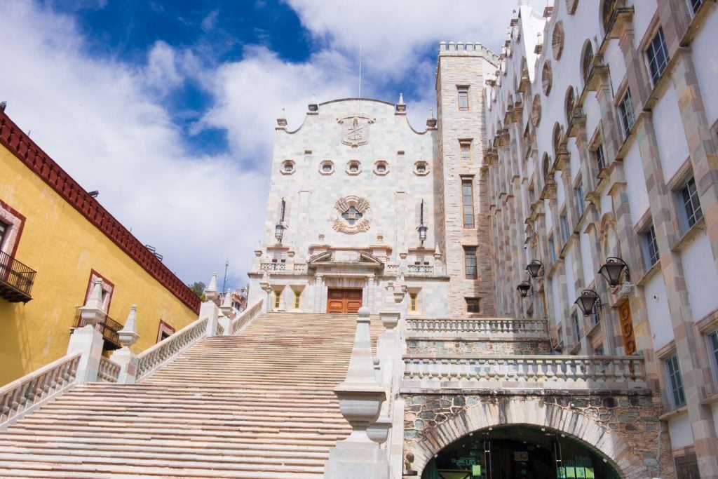 A white almost gothic stone building with lots of stairs in the center of Guanajuato.