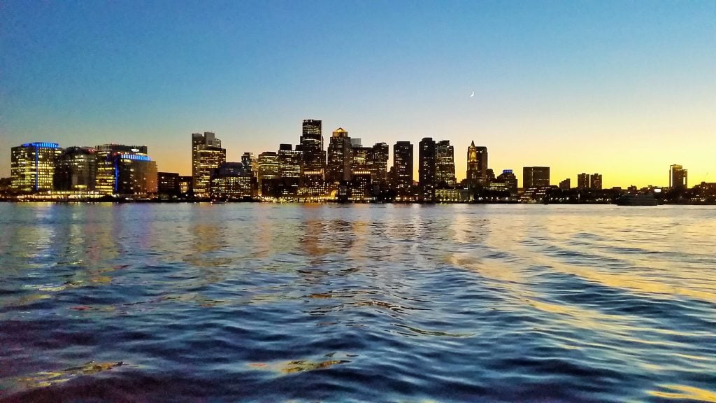 The Boston skyline at sunset, taken from the water. 