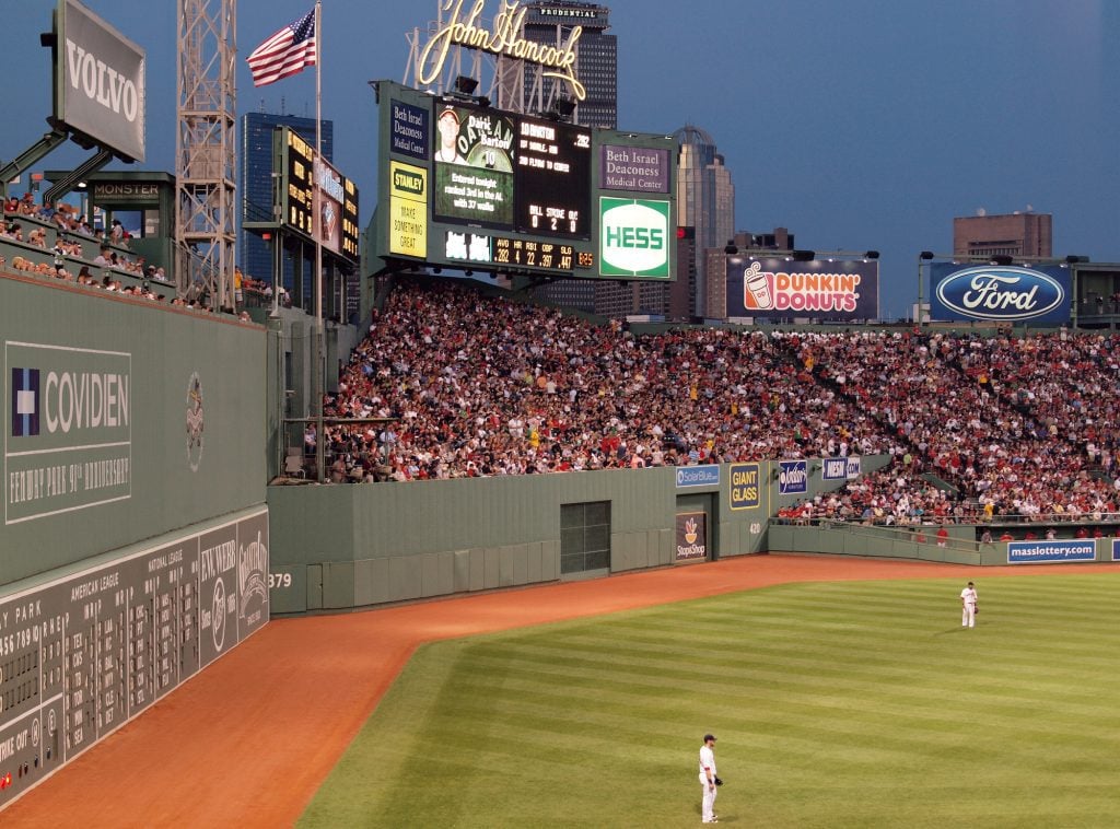The Red Sox play on the field at Fenway Park.