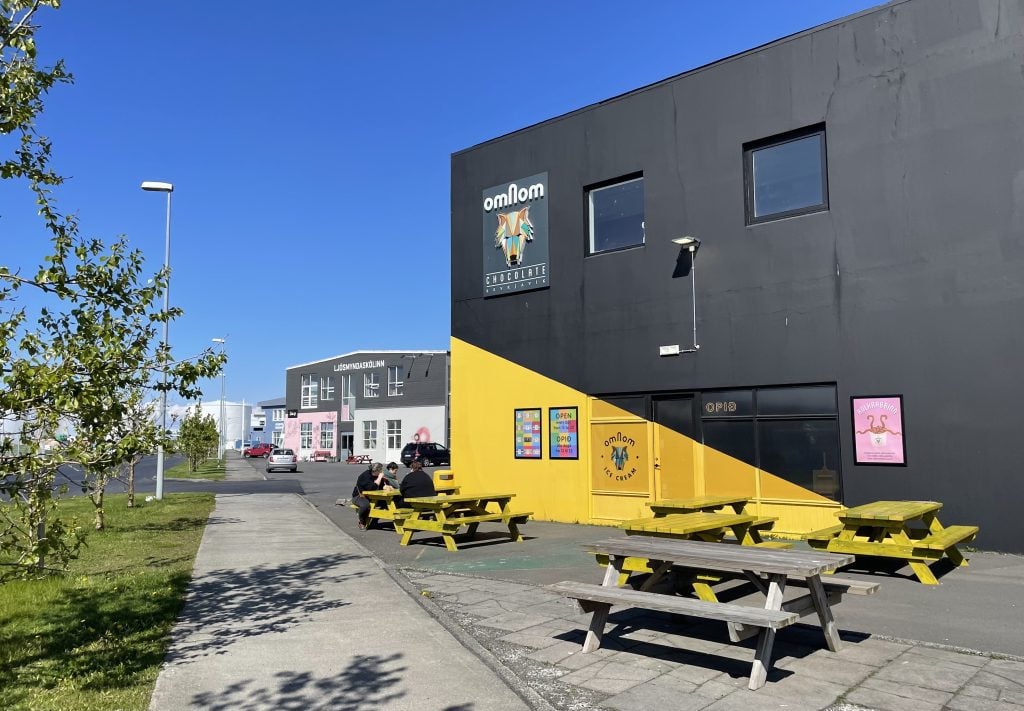 The outside of the OmNom Chocolate building, with a big yellow diagonal stripe across the black building.