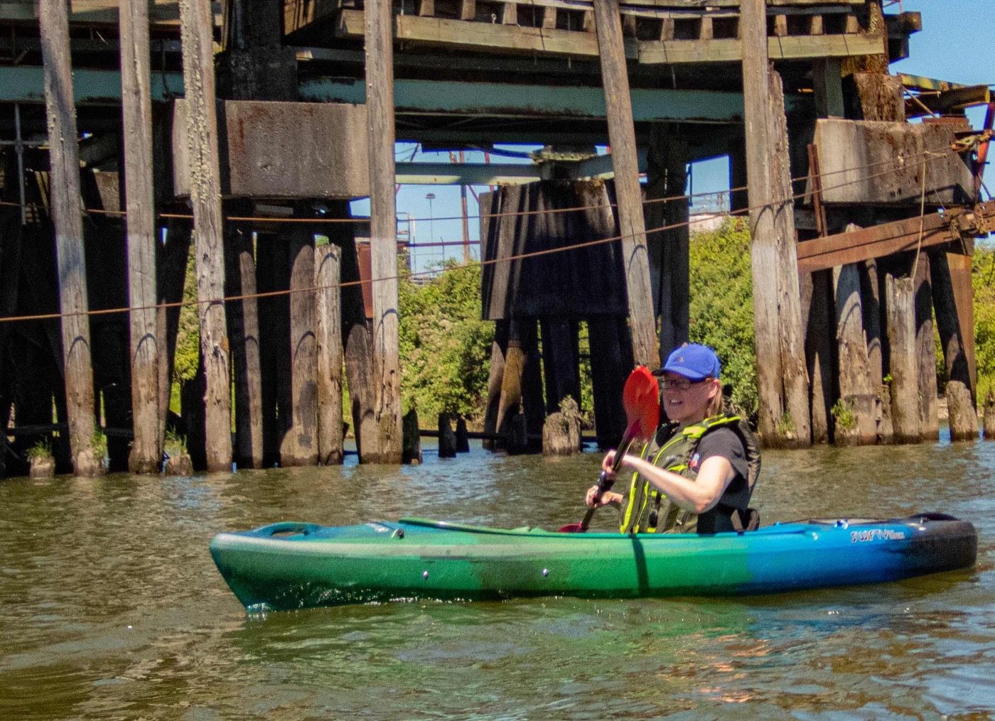 Sue in a blue and green kayak on the Columbia River