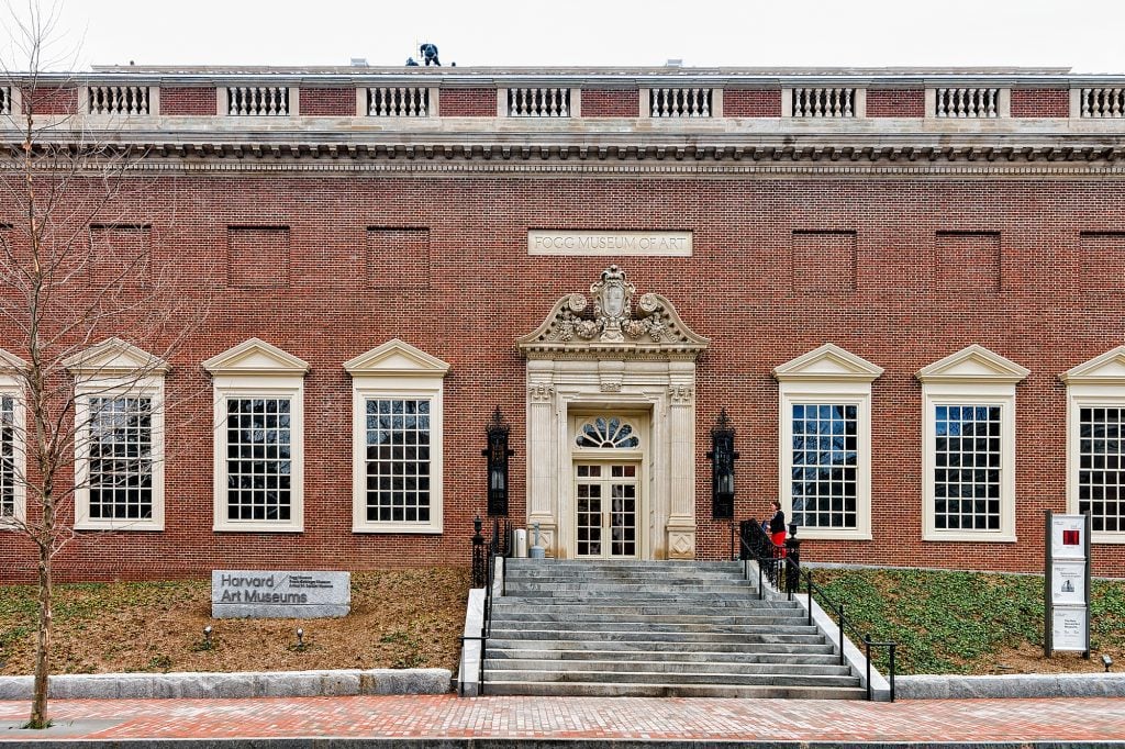 A smaller brick building with big windows and a concrete sign reading Fogg Museum of Art.