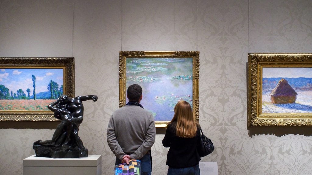 A couple paused in front of one of Monet's paintings of water lilies.