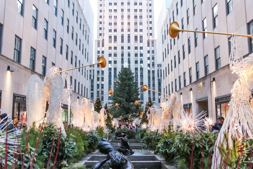 A tall Christmas tree in the center of Rockeller Center