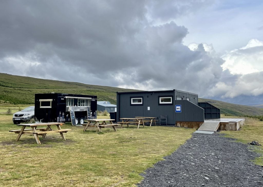 A small gray building marked WC in the middle of nowhere.