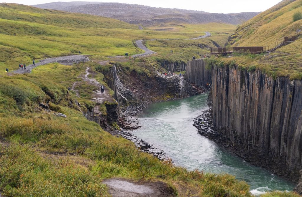 The canyon, lined with basalt columns in every direction, and a gravel hiking path along the wide of it.