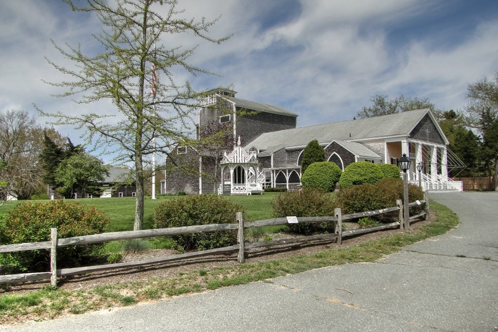 A gray-and-white old meeting house where there's now a theater.