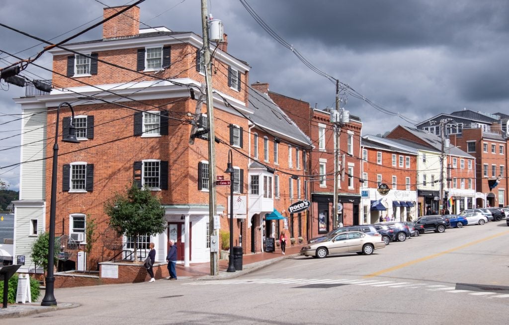 A row of red brick buildings leading up a hill in Portsmouth, NH.