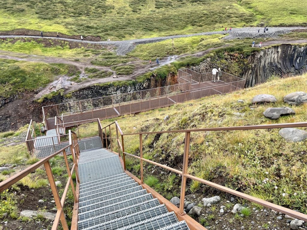 A long downward staircase leading to a platform overlooking the canyon.