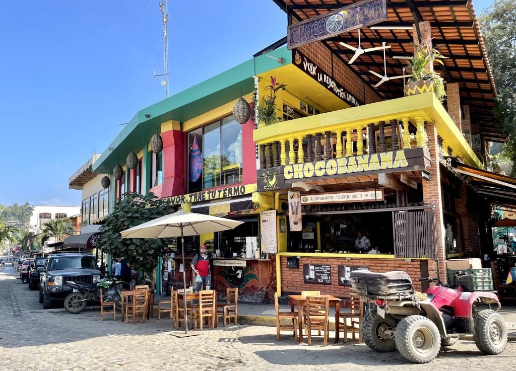 A line of restaurants including the bright yellow Chocobanana restaurant.