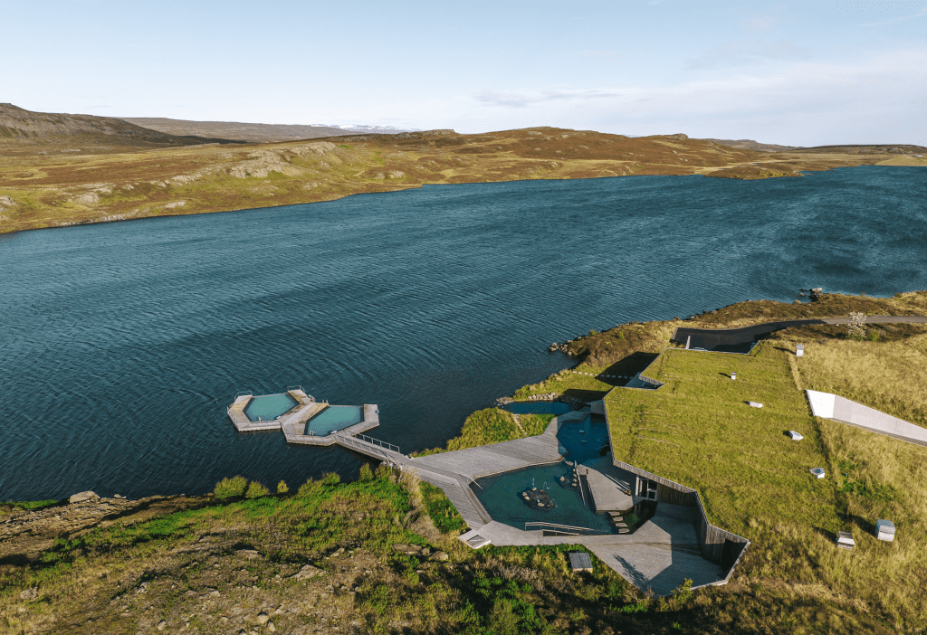 An aerial view of a series of pools on the edge of lake, with two hexagon-shaped pools right in the lake water.