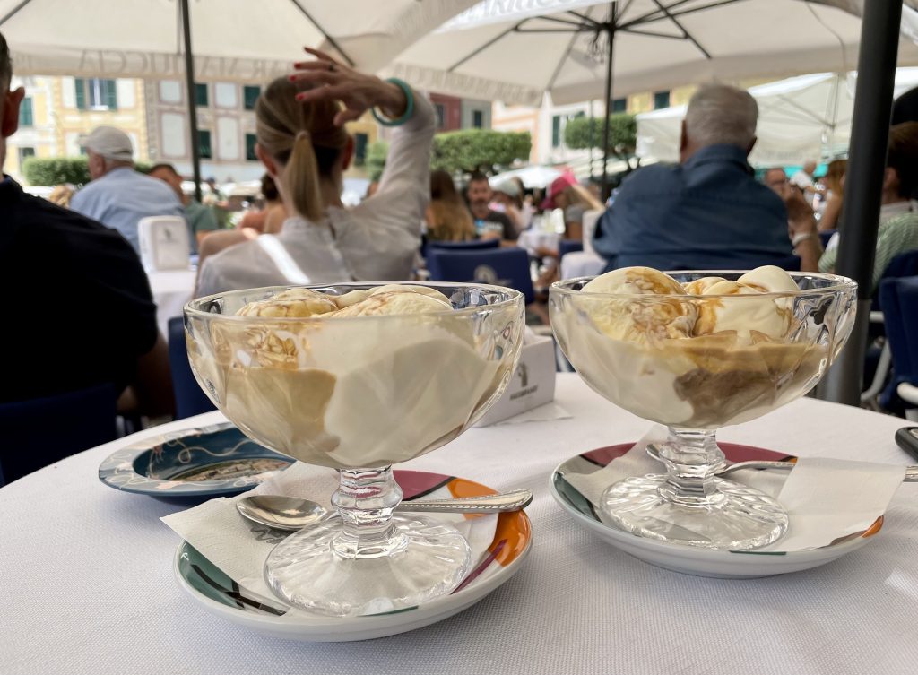 Two large glass ice cream dishes filled with vanilla gelato and espresso.