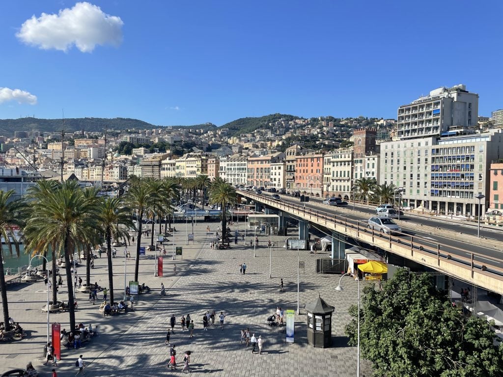 Aerial view of a park in Genoa with the city and mountains in the background