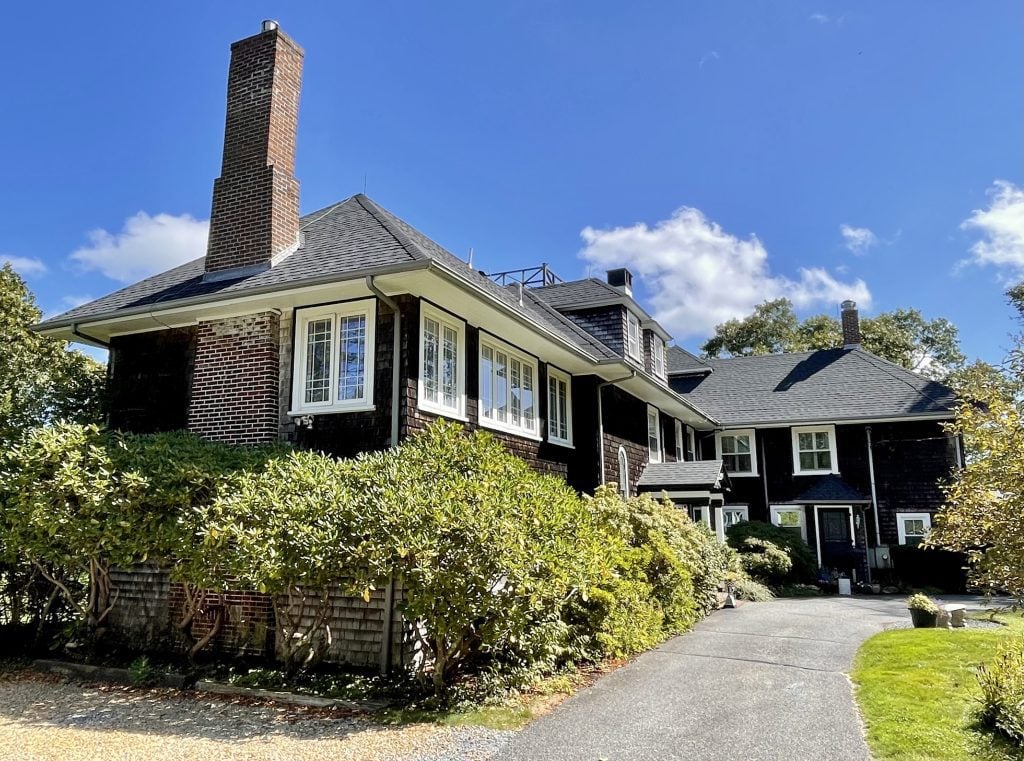 A large Martha's Vineyard mansion at the end of a driveway.