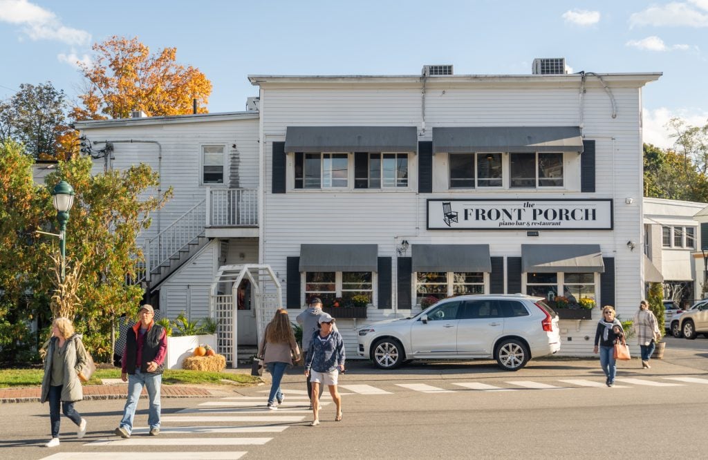 A big white building reading Front Porch Piano Bar.