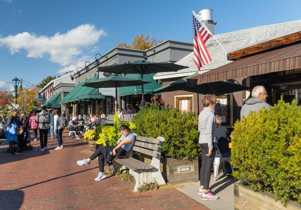 A red brick downtown with outdoor cafes and benches.