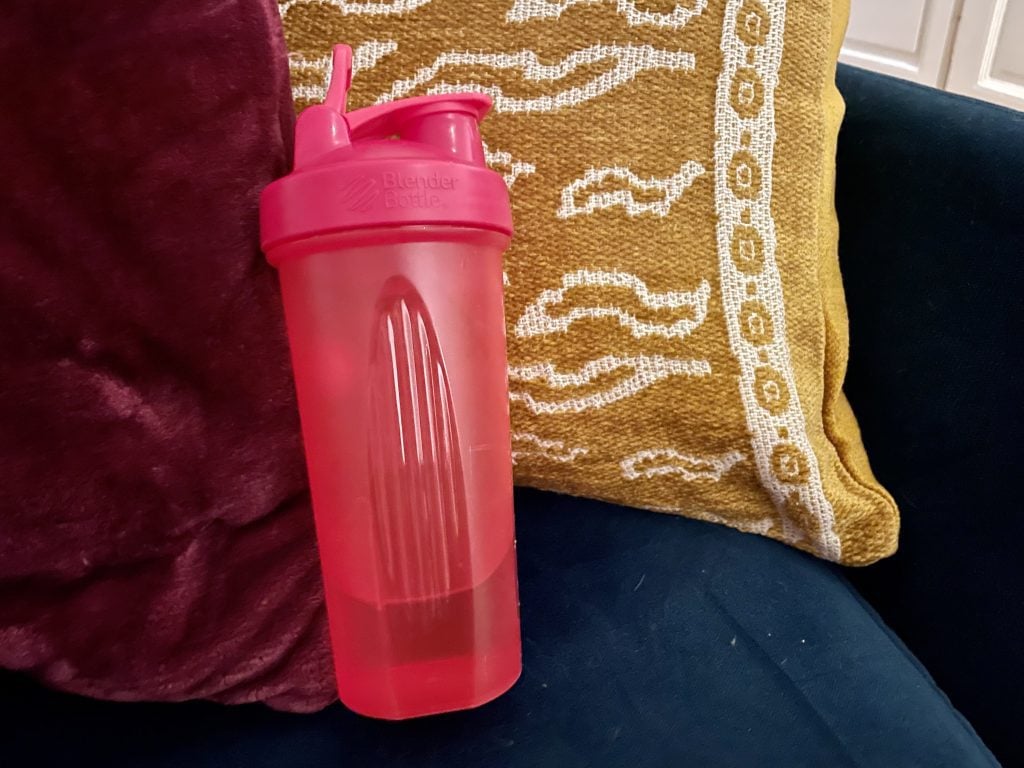 A bright pink plastic water bottle