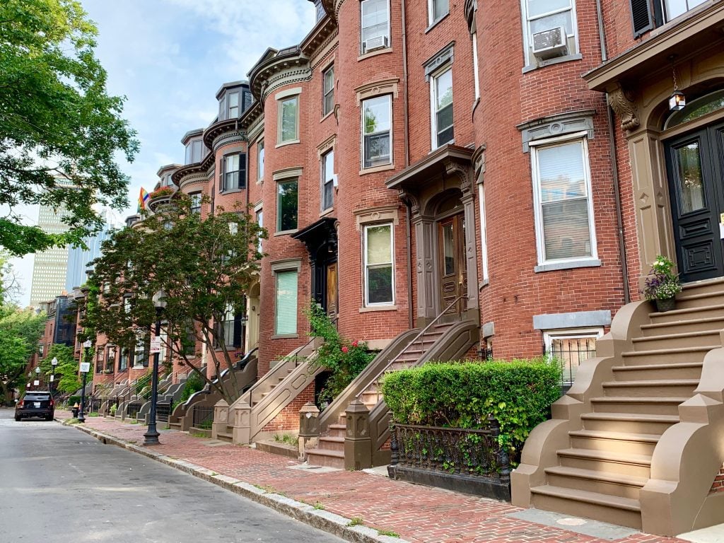 A long row of brownstones on a Boston street.