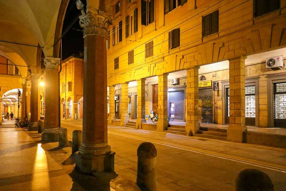 Angled view of the porticoes of bologna lit up at night