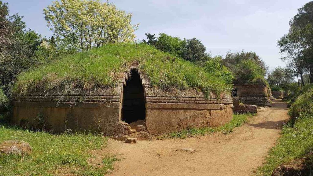 A grassy dome house with an open door at the Etruscan Necropolises