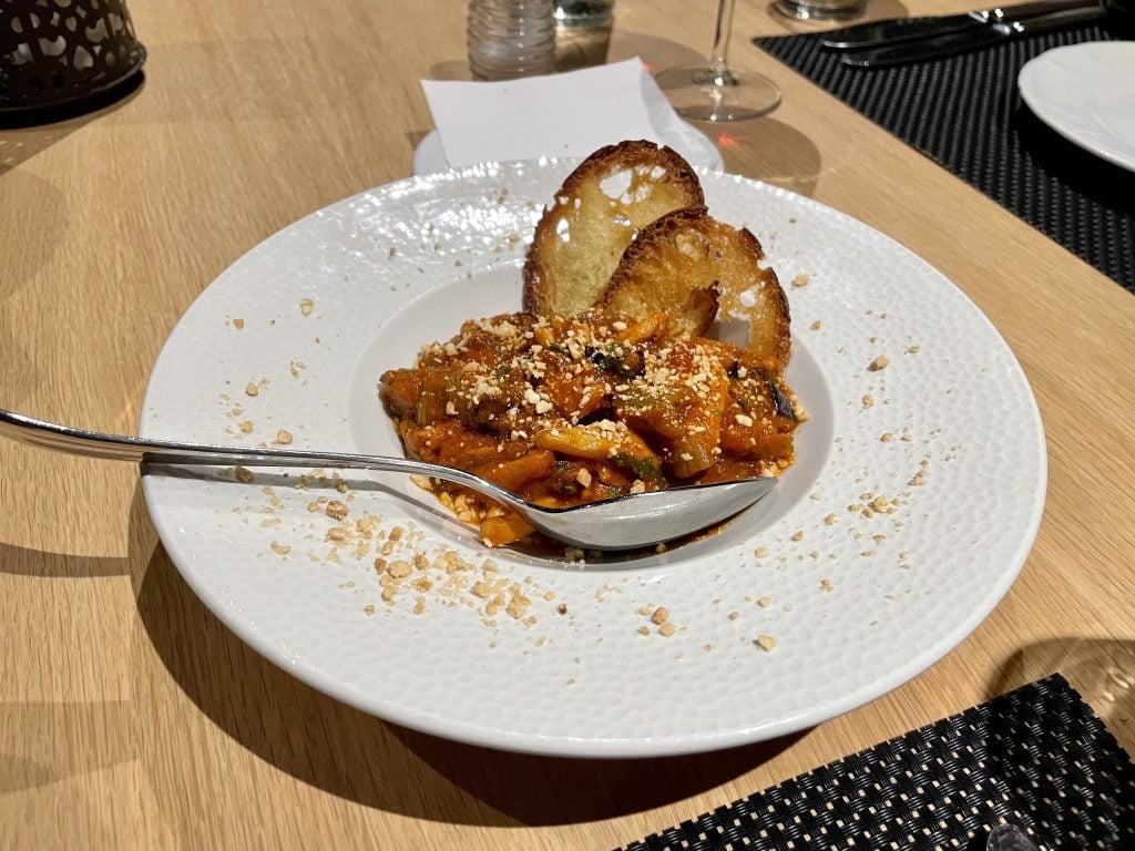 A plate with caponata (Sicilian dish with fried eggplant and vegetables in tomato sauce)