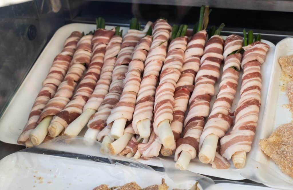 Rows of veal intestines wrapped around spring onions, ready to be grilled.