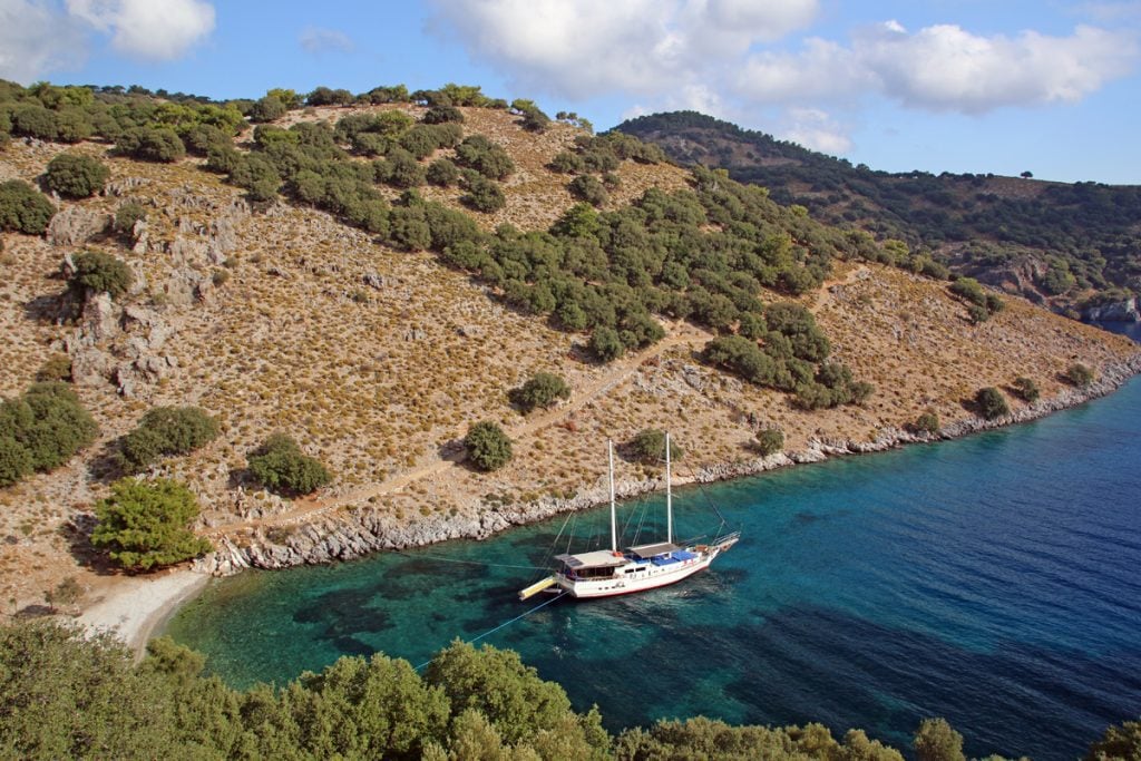 Aerial view of a white boat in a narrow bay of the 12 Islands near Fethiye Bay