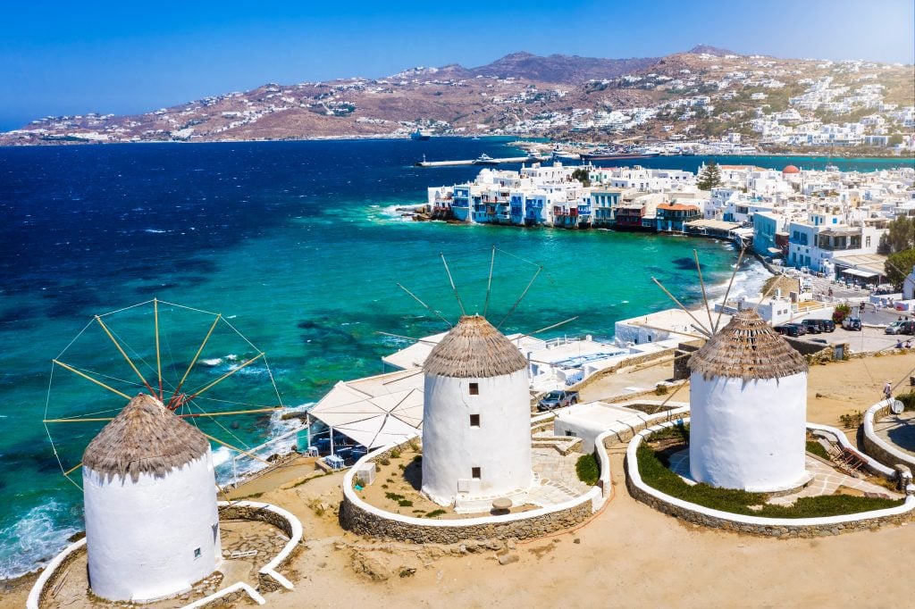 Aerial view of windmalls and the blue ocean in Mykonos, one of the best Mediterranean islands to visit