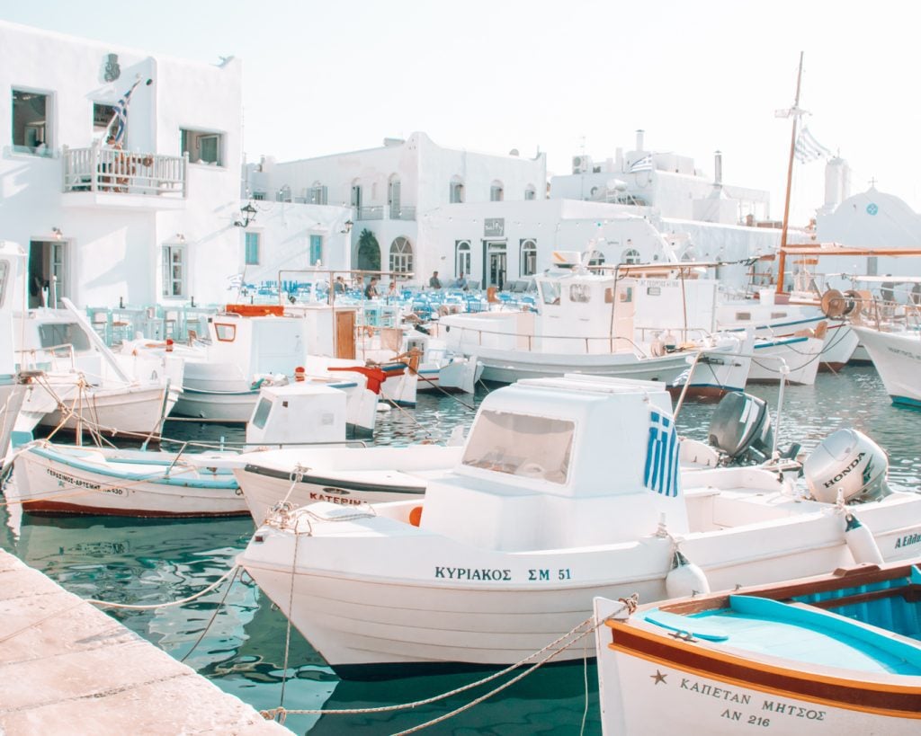 White boats in front of white buildings on the island of Paros