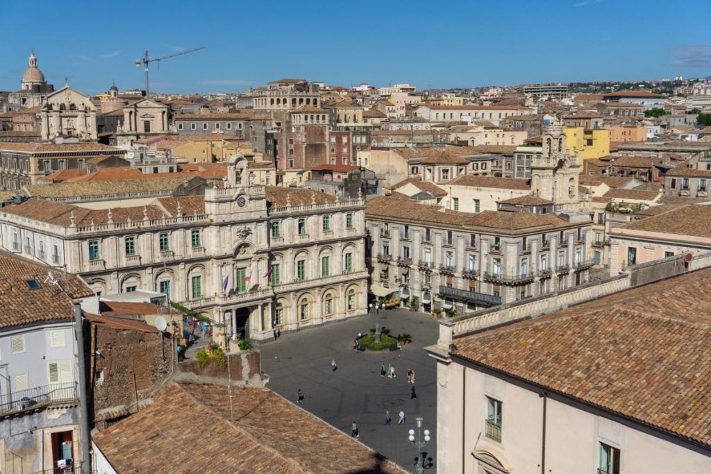 Aerial view of a square in Catania Italy, with white buildings around it