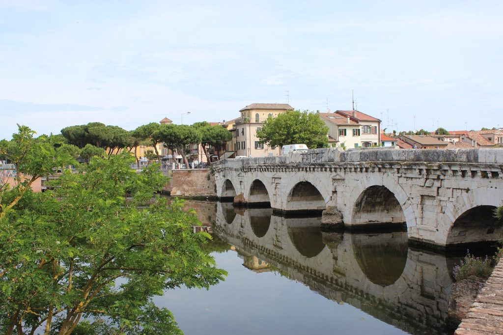 A bridge in Rimini Italy reflected back into the water