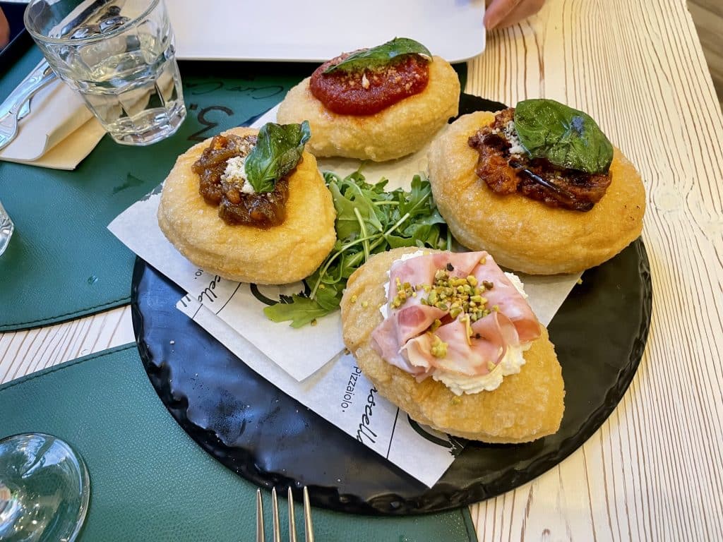 Little donut-like fritters topped with various pizza toppings.