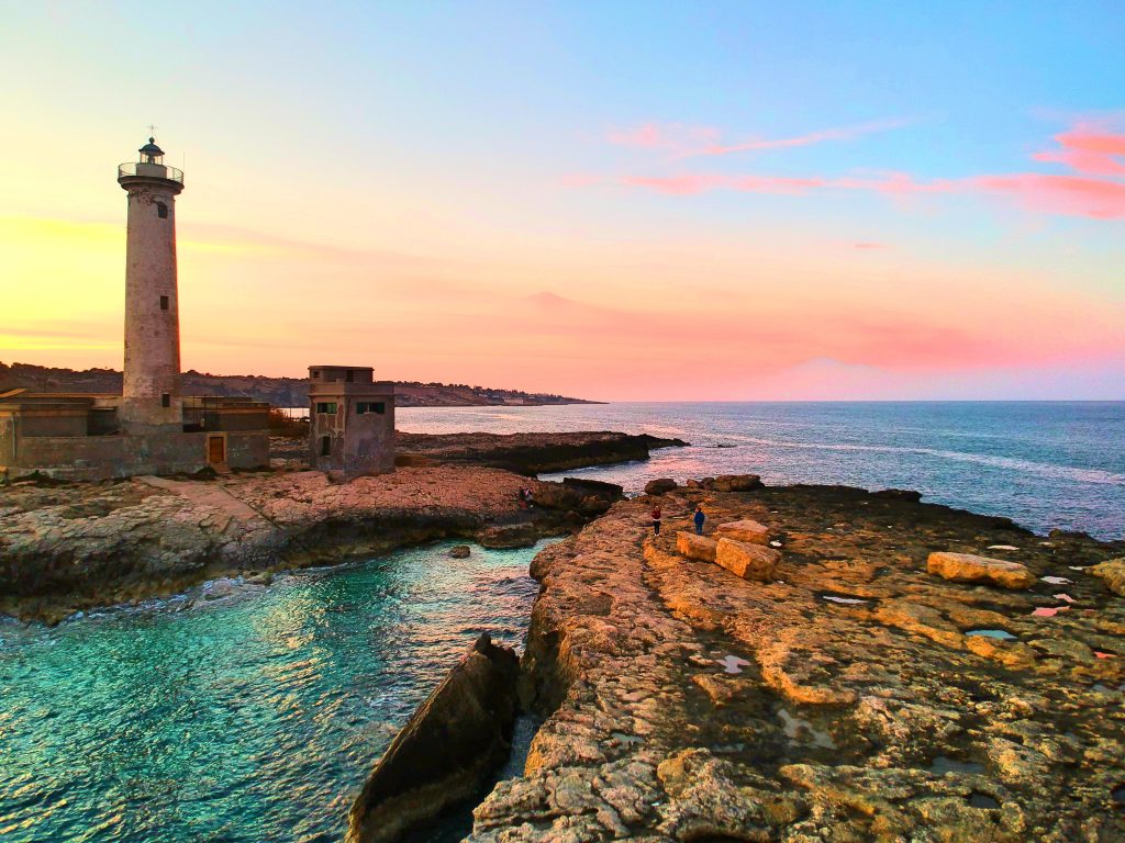 Sunset at the lighthouse in Augusta, one of the best places to visit in Sicily