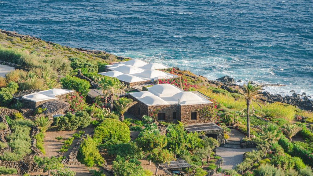 Aerial view of houses along the coast of Pantelleria, one of the best places to visit in Sicily