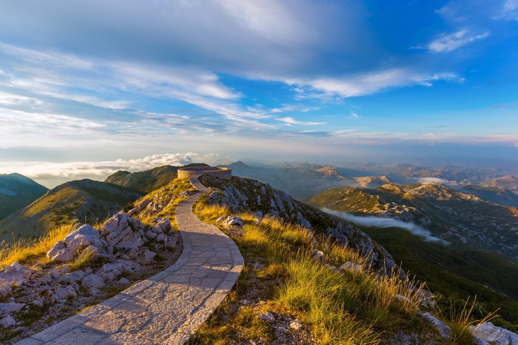 A view from the top of a mountain, a path leading to a round observation area.