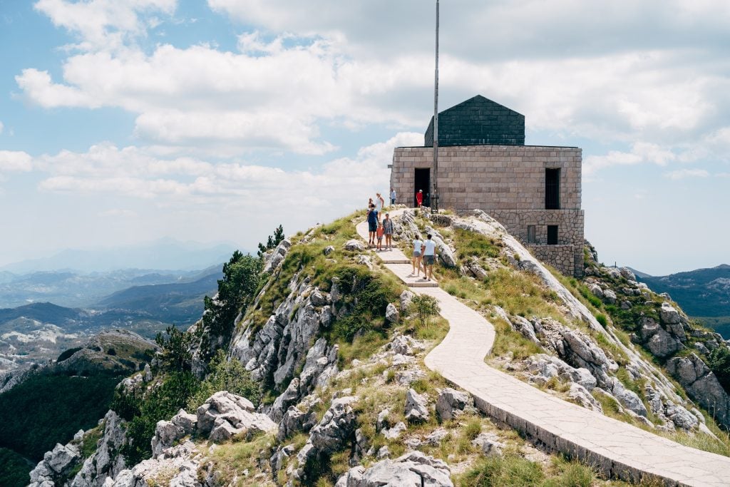 A pathway leading up to a mausoleum on top of a mountain.