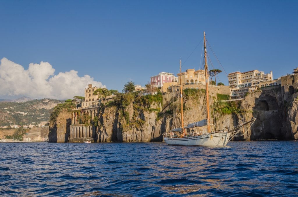 A tall ship sailing along the cliffs of Sorrento.