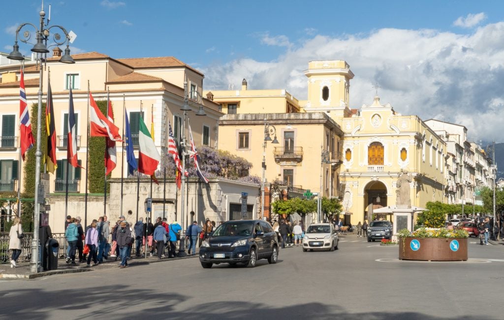 A town square surrounded by square sand-colored buildings in Sorrento