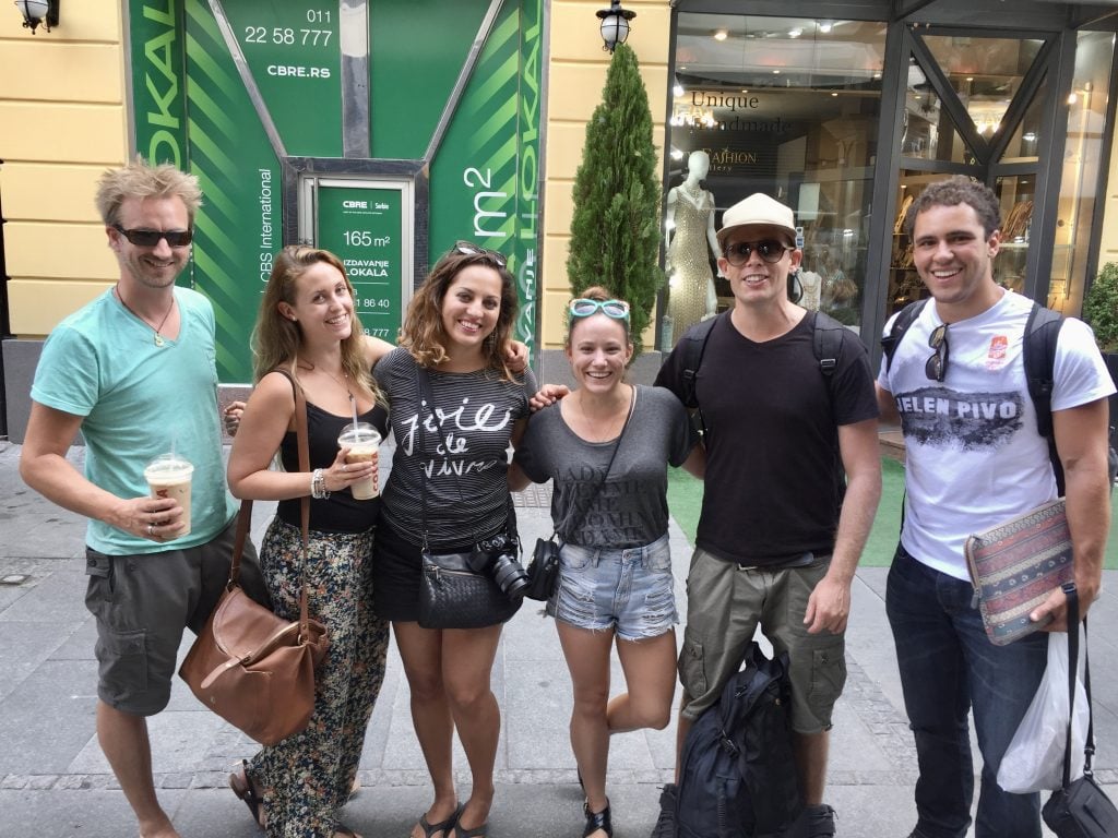 Six friends posing arm-in-arm in Belgrade, including Kate and her friend Leah in the middle.