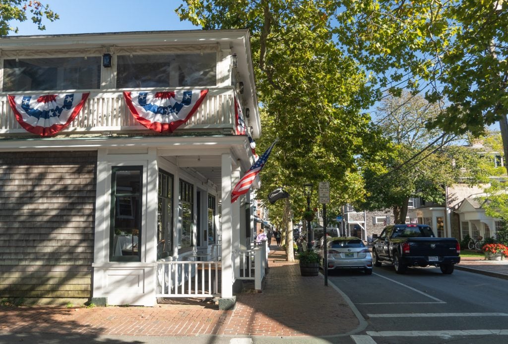 A quiet street in Edgartown, with a boutique decked out in patriotic red white and blue bunting.