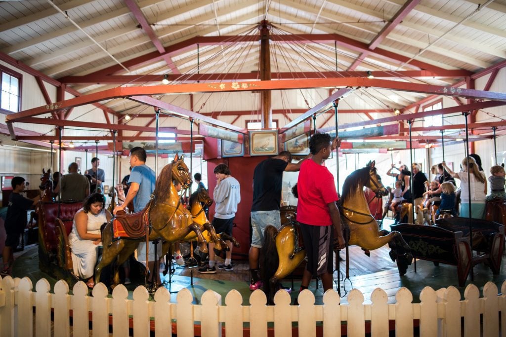 People riding an old-fashioned carousel in Martha's Vineyard.