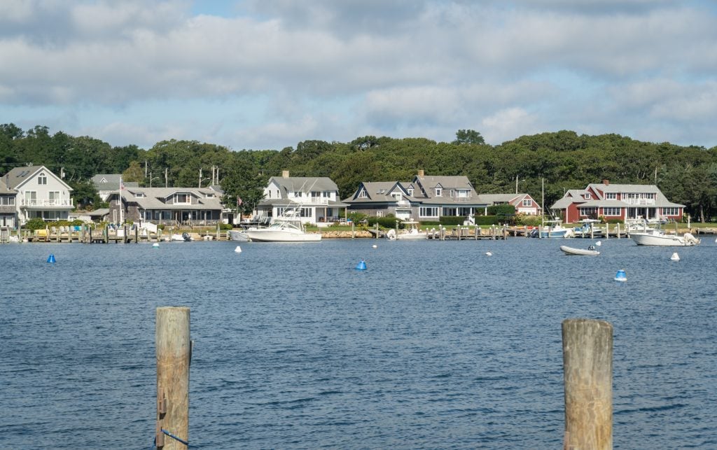 The view across the bay in Oak Bluffs, Martha's Vineyard, several waterfront homes in the distance.