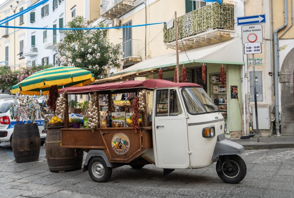 A tiny Italian truck converted into a shop selling dried peppers and garlic out the back.