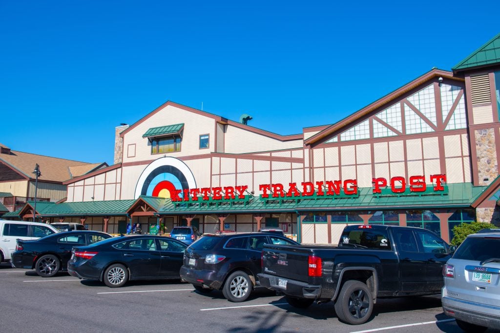 The Kittery Trading Post, a building with a giant bullseye painted on it, with lots of cars parked in front.