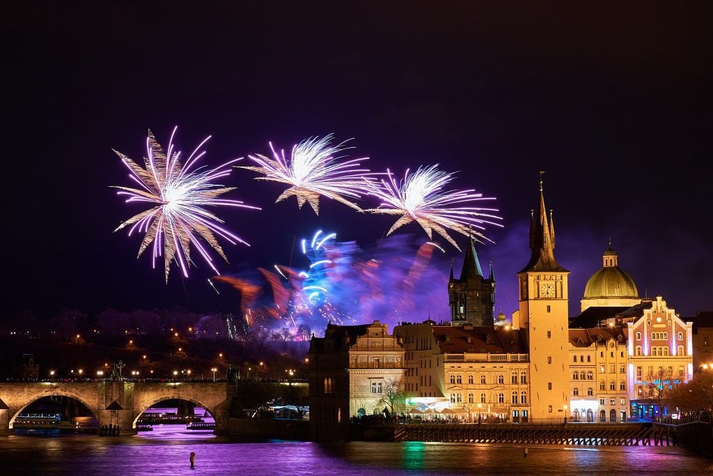 Fireworks exploding over the medieval-era Charles Bridge in Prague.