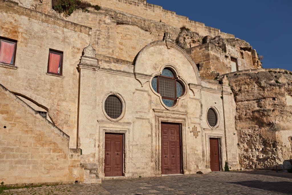 A simple church facade carved into a big, flat piece of rock in Matera.