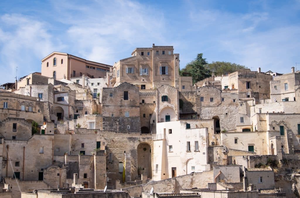 Another angle of stone square buildings piled on top of each other in Matera, Italy.