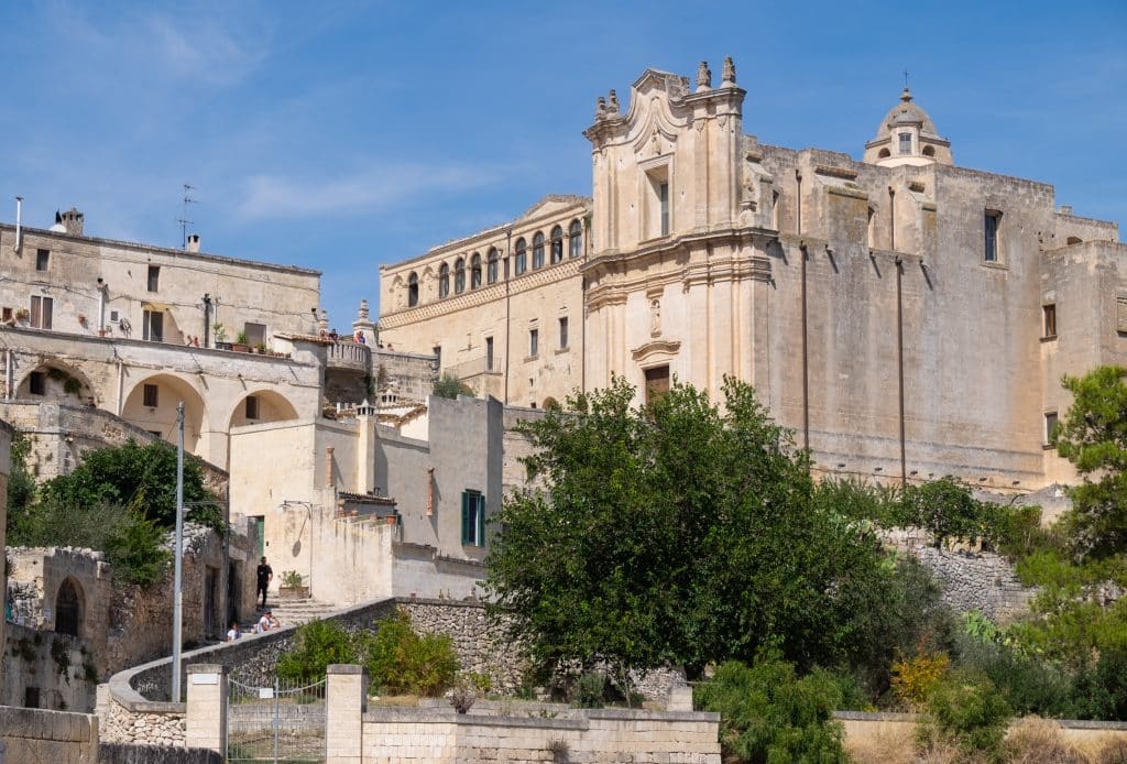 A tall, square-looking stone church in Matera, Italy.