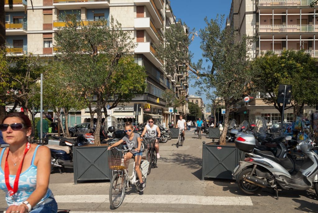 People riding bicycles in the streets of Bari.