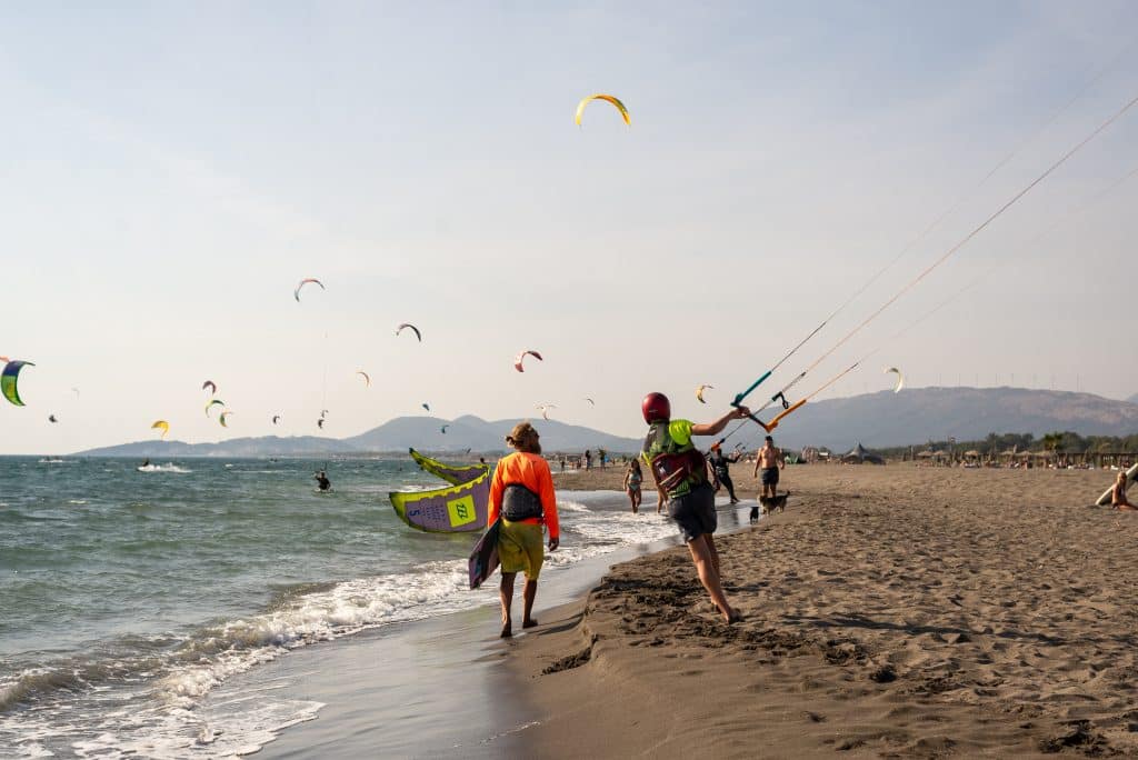 Kitesurfers flying around on a soft beach in Montenegro.